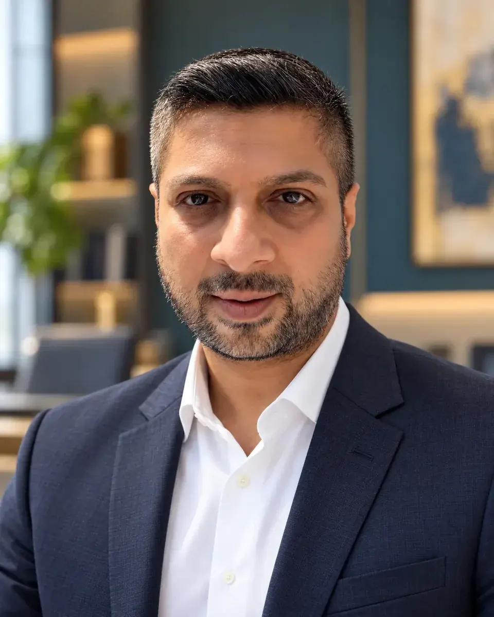 Pravesh Rajdev in a navy jacket in an office